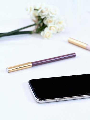 coffs harbour turned off black Android smartphone near brown pen on white surface australia
